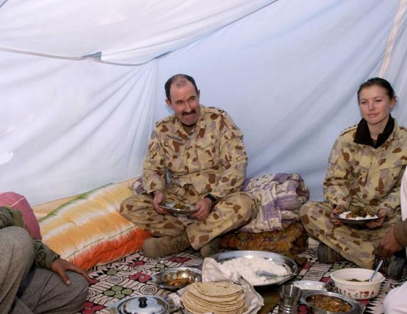 The Imam of Qaziabad (left) hosts a meal with Major 'Spud' Murphy, Captain Jada Bendall and interpreter Arshad during the visit of an Australian Defence Force medical team to remote areas of Kashmir