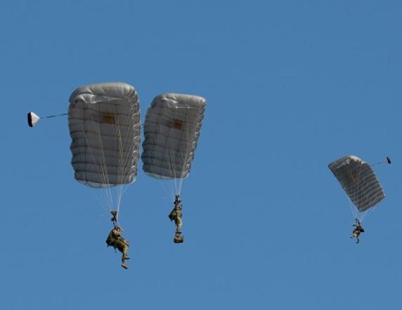 Australian Army soldiers from the Red Berets parachute display team at the Australian Defence Force Parachuting School conduct a freefall jump from a Royal Australian Air Force C-130J Hercules aircraft as part of the Australian Defence Force Academy open day in Canberra on Saturday, 19 August 2023.