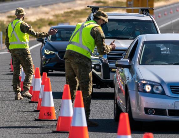Australian Army soldiers assist the Western Australian Police Force at a vehicle check point on Forrest Highway in Lake Clifton, Western Australia.