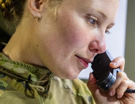 Australian Army officer Lieutenant Grace Middleton from Headquarters 9th Brigade, passes information on the radio during Exercise Rhino Run 24 at the Cultana Training Area, SA.