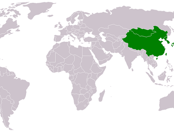 A white and grey map of the world with East Asia highlighted in Green 