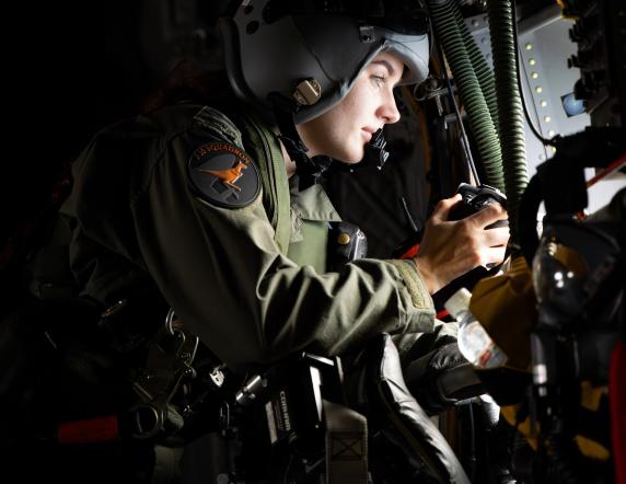 Royal Australian Air Force Loadmaster Corporal Monique Jeynes prepares to collect imagery of fishing vessels from inside a C-27J Spartan aircraft during Operation Solania, Fiji.