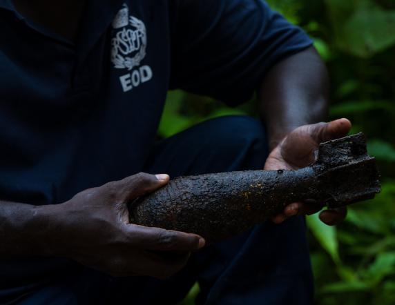 Australian Army Corporal Solomon Boyd and Royal Solomon Islands Police Force officer Tusa consolidate Explosive remnants of war (ERW) located in the Solomon Islands during Operation Render Safe, Munda, Solomon Islands.
