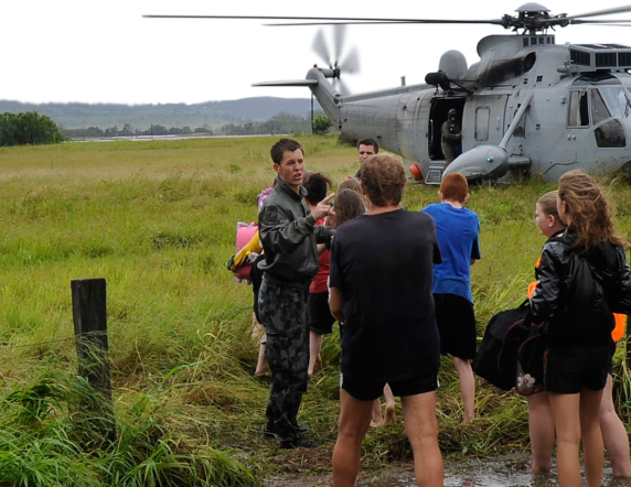 Royal Australian Navy personnel help civilians stranded due to major flooding. The civilians were safely evacuated on a RAN helicopter.
